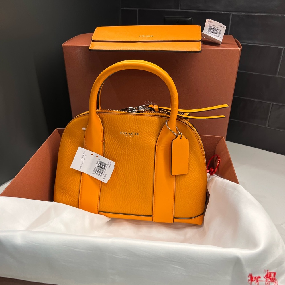 Coach Purse and Matching wallet.  Orange color. Approximately 10”x8”x5”. New.